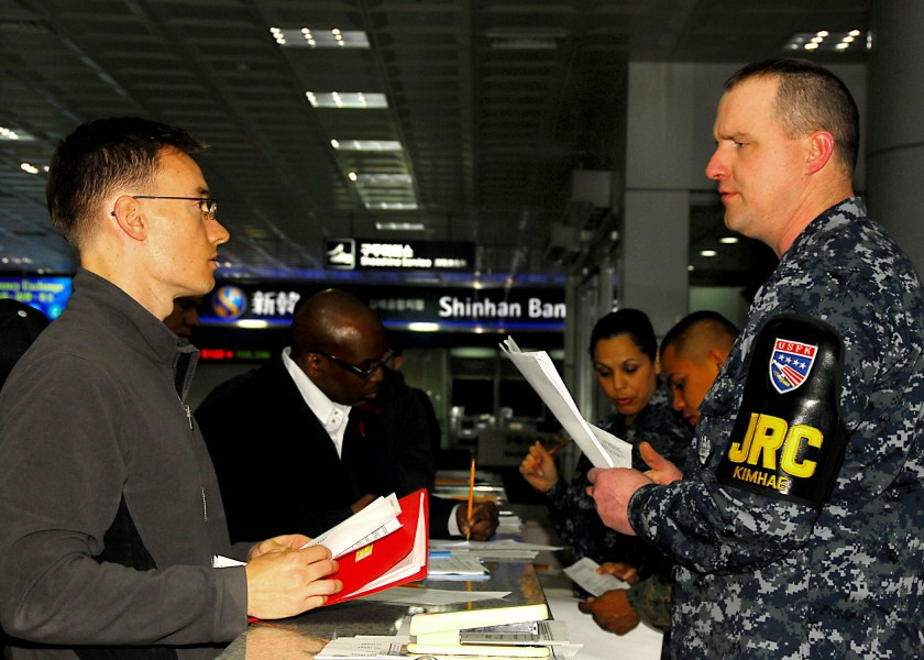 US Navy 100306-N-9573A-018 Equipment Operator 2nd Class Daniel O'Bryant helps a Sailor at Gimhae International Airport during Key Resolve-Foal Eagle 2010