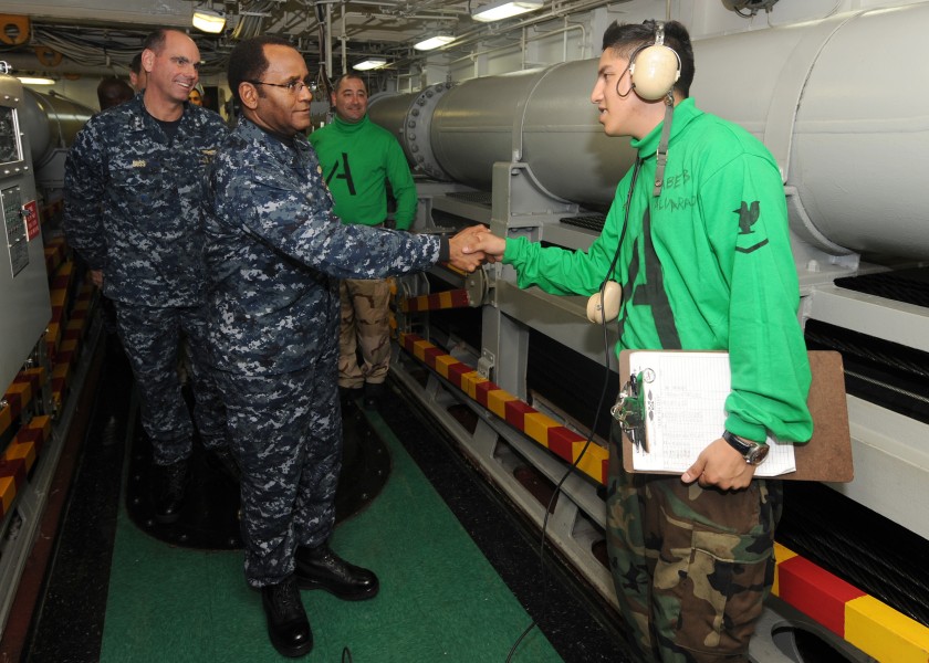 US Navy 100519-N-5082P-028 Vice Adm. Mel Williams Jr., commander of U.S. 2nd Fleet, greets Aviation Boatswain's Mate (Equipment) 3rd Class Jairo Alvarado inside arresting gear room number 3 aboard the aircraft carrier USS Enter