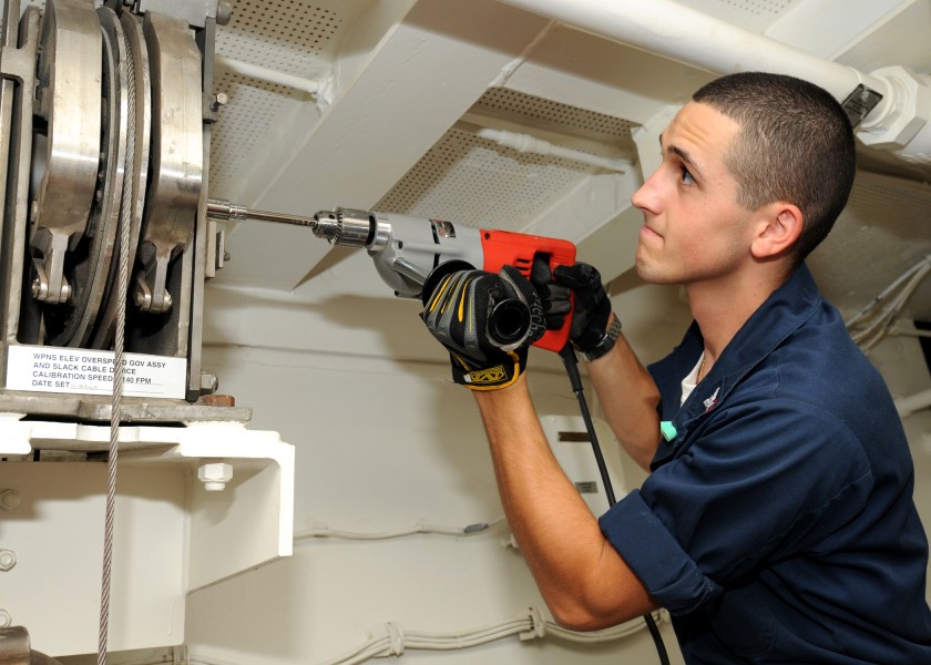 US Navy 100612-N-7908T-019 Aviation Ordnanceman 3rd Class Robert H. Little calibrates the overspeed governor in the ship's lower stage one machinery room aboard USS George H.W. Bush (CVN 77)