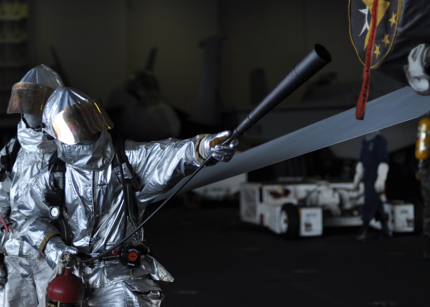 US Navy 100629-N-2013O-053 Aviation Boatswain's Mate (Handling) 3rd Class Dustin Dixson, from Crestview, Calif., checks for hotspots on an F-A-18E Super Hornet during a general quarters drill aboard the aircraft carrier USS Geo