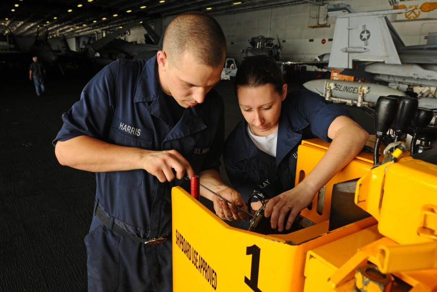 US Navy 100726-N-1092P-088 Aviation Ordnanceman David Harris, from Greenville, N.C., and Electrician's Mate Fireman Cheryl Fendlay, from Salem, Va., repair the potentiometer on a forklift