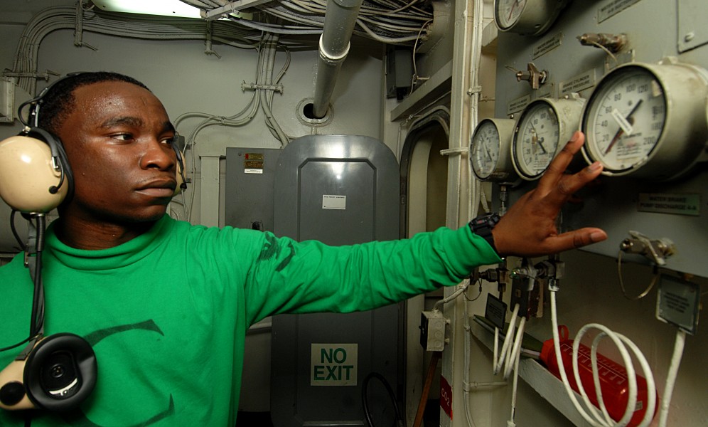US Navy 100831-N-6582H-046 Aviation Boatswain's Mate (Equipment) 3rd Class Lavon Jackson, from Gadsden, Ala., checks water pressure and temperature gauges in a catapult room