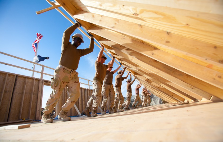 US Navy 101104-N-6383T-508 Seabees assigned to Naval Mobile Construction Battalion (NMCB) 18 erect an exterior wall for a Southwest Asian Hut at Ka