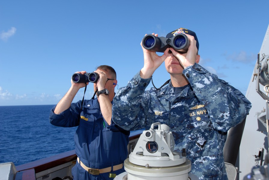 US Navy 110422-N-ZI300-040 Cmdr. Christopher Nerad, executive officer of the guided-missile destroyer USS Nitze (DDG 94), and Capt. Marc Weeks, com
