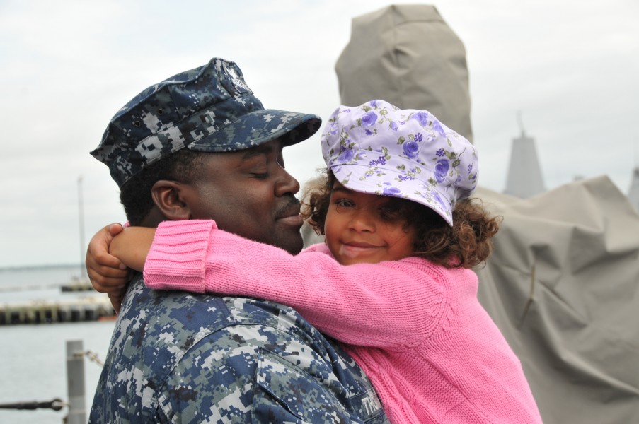 US Navy 110511-N-QY430-007 Fire Controlman 1st Class Rodney Thomas holds his daughter one last time aboard the guided-missile cruiser USS Anzio (CG