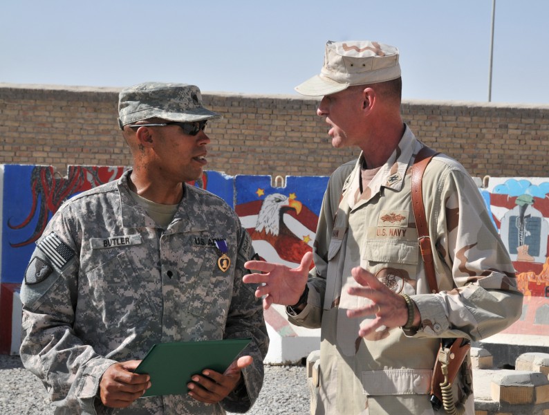 US Navy 110606-N-IA881-002 Spc. Johnny J. Butler Jr. talks with Capt. Allan M. Stratman after receiving the Purple Heart medal