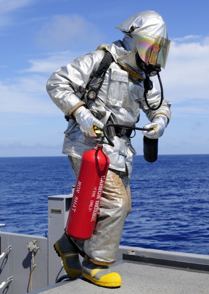 US Navy 110927-N-WJ771-100 Aviation Support Equipment Technician 2nd Class Joshua B. Cary carries a CO2 fire extinguisher onto the flight deck of U