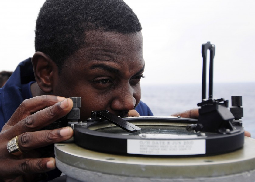 US Navy 111003-N-WJ771-014 Chief Quartermaster Raymond E. Smith uses an azimuth circle from the port bridge wing of the forward-deployed amphibious