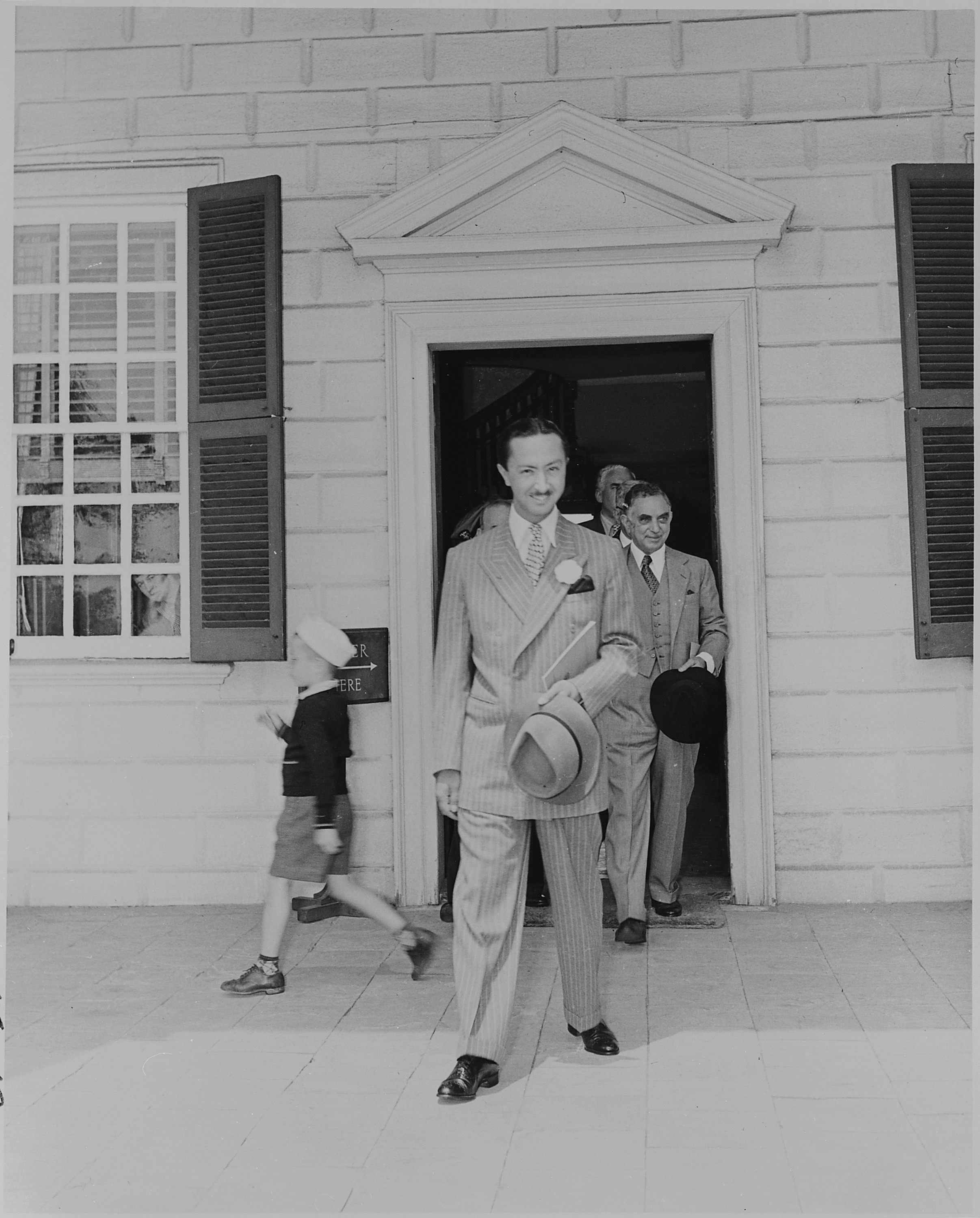Prince Abdul Ilah of Iraq, walking out the door of George Washington's home at Mt. Vernon, Virginia. - NARA - 199094