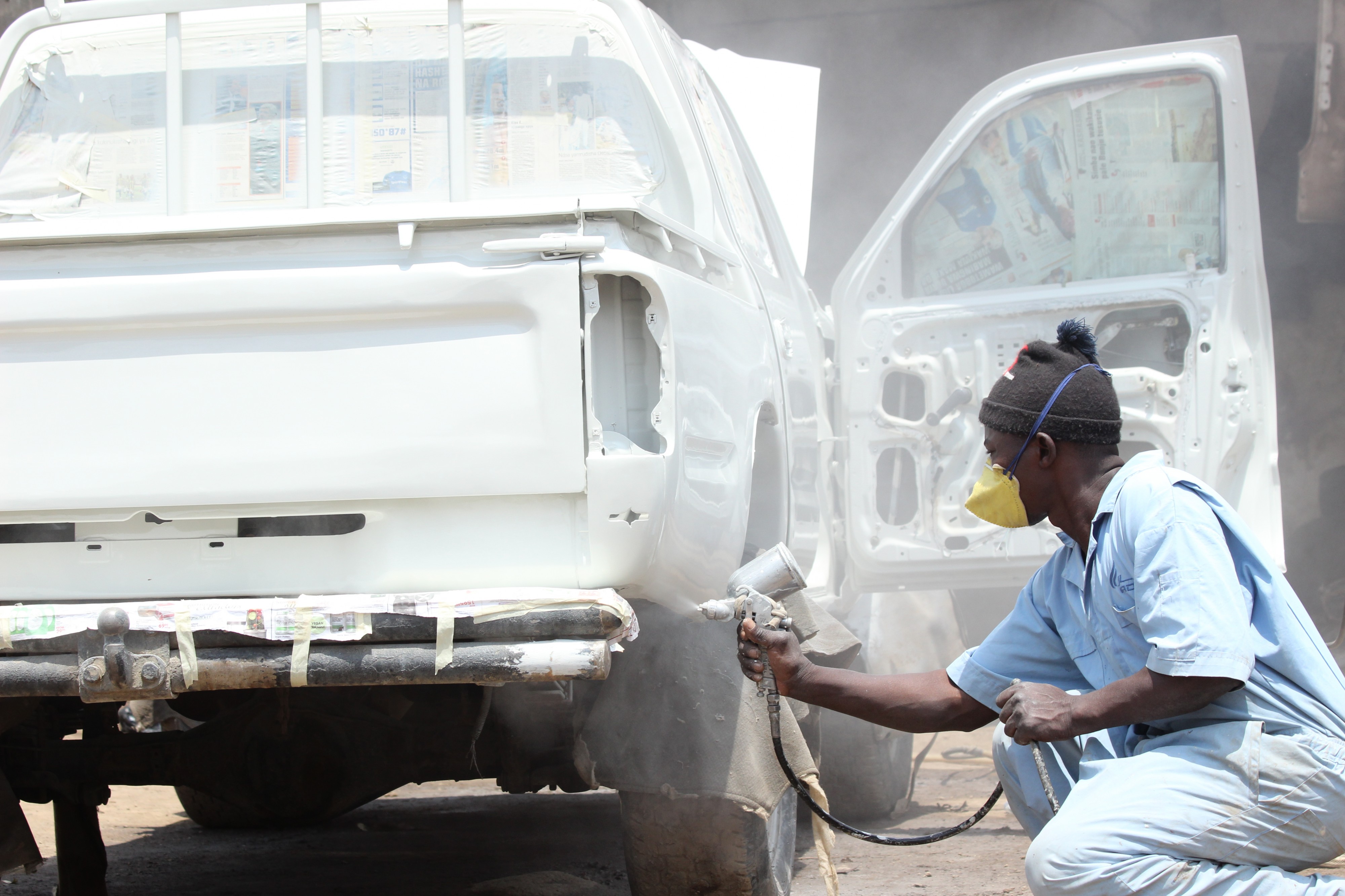 A man is painting a car
