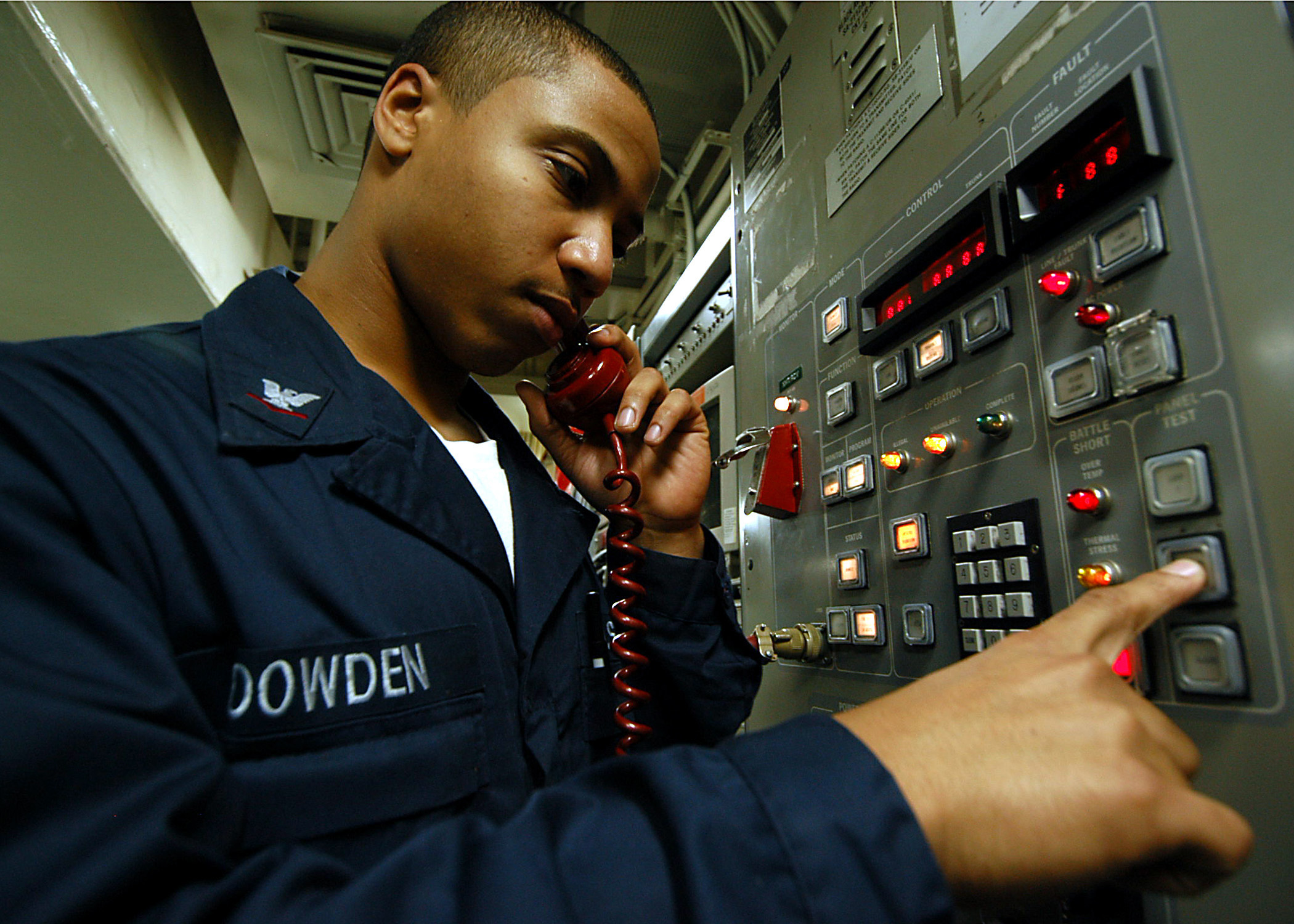 US Navy 040210-N-6278K-001 Information Systems Technician 3rd Class Anthony Dowden from Brooklyn, N.Y., conducts a communications check on a UHF circuit aboard USS George Washington (CVN 73)