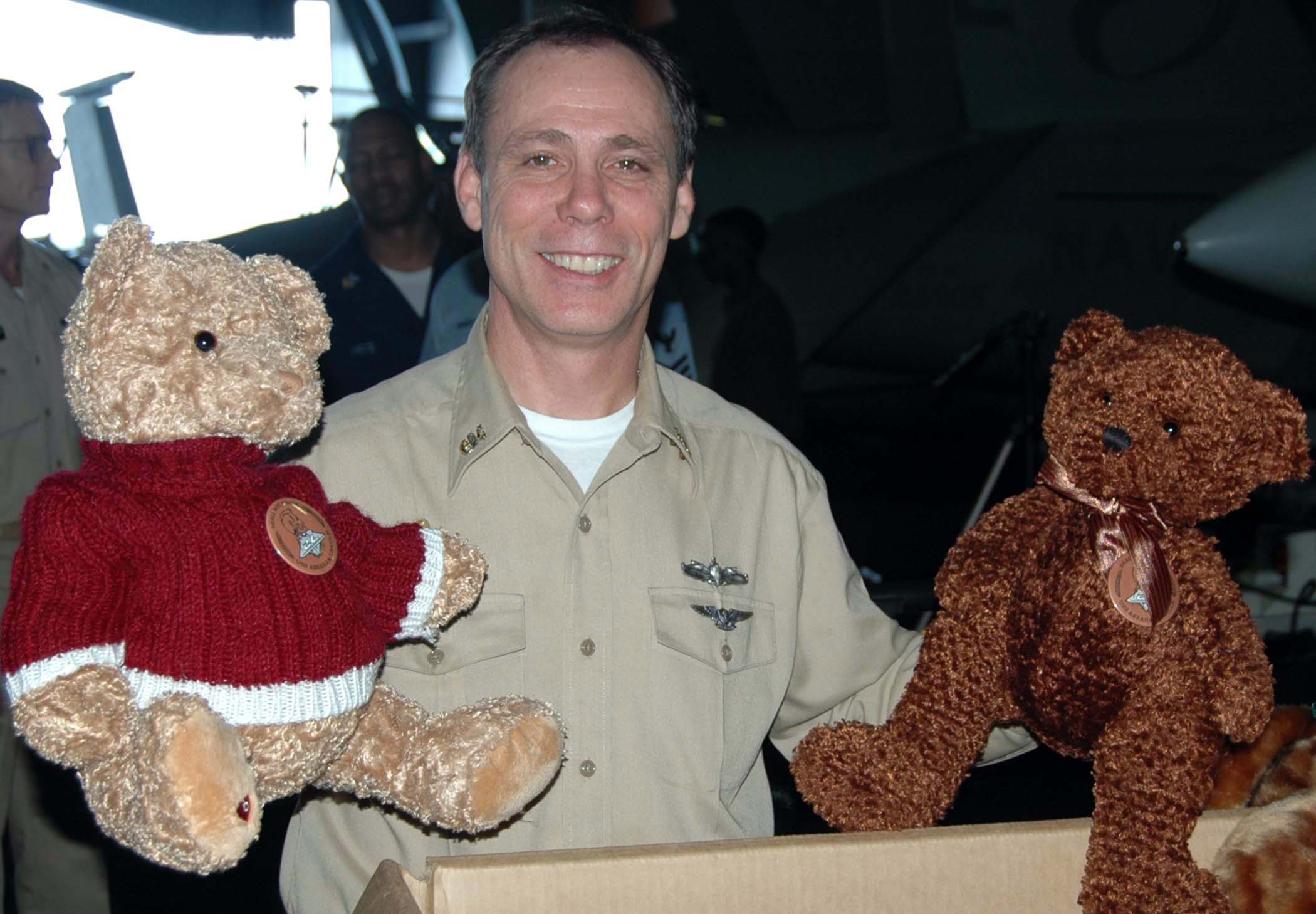 US Navy 050106-N-9403F-001 Command Master Chief J. O'Bannon holds toy bears during a toy drive held aboard USS Abraham Lincoln (CVN 72)