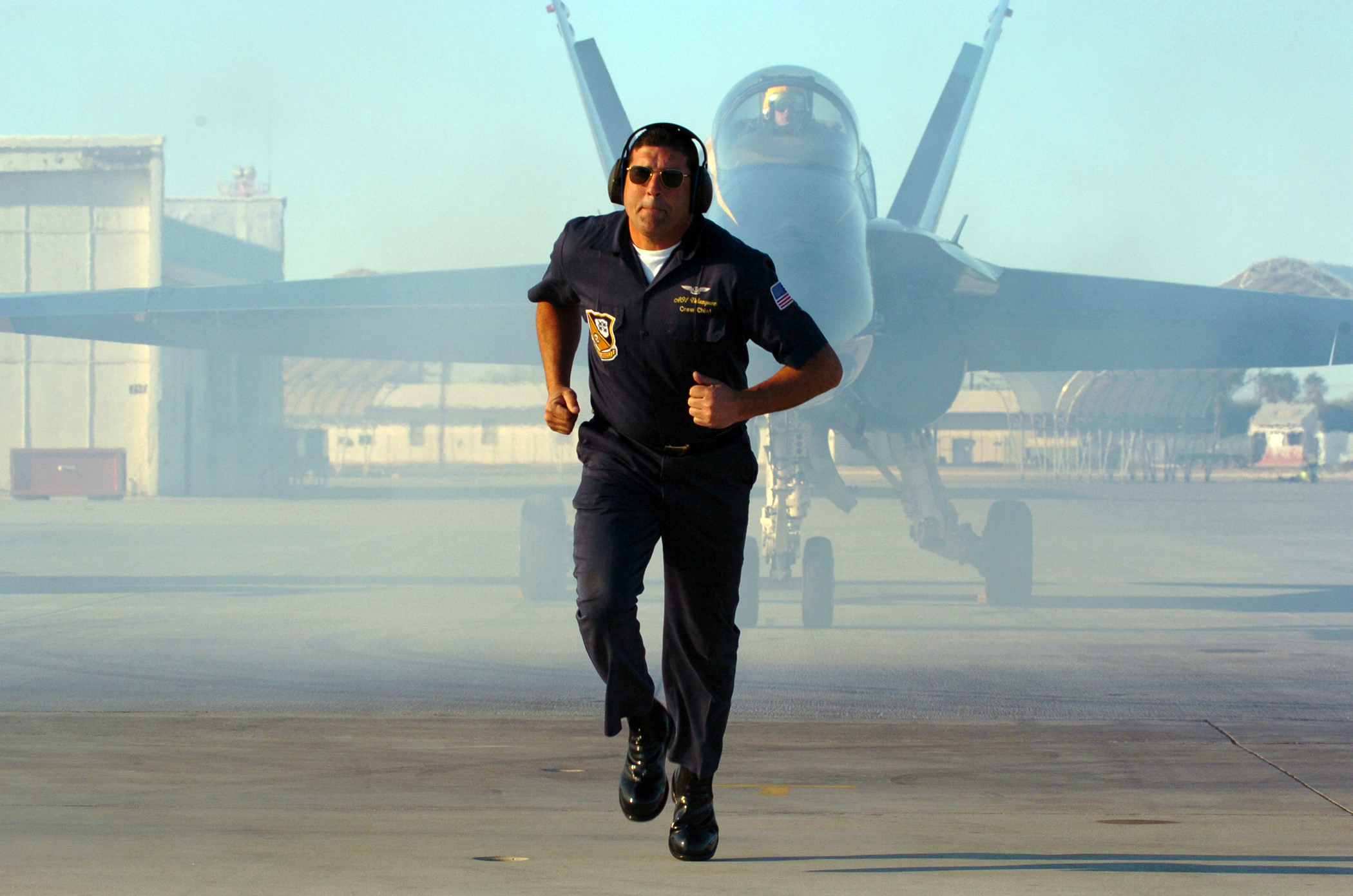 US Navy 050202-N-3874J-002 Crew Chief Aviation Ordnanceman 1st Class Eric Velazquez of Ceiba, Puerto Rico, moves to a safe location, as his Blue Angel F-A-18A Hornet starts to taxi prior to take off