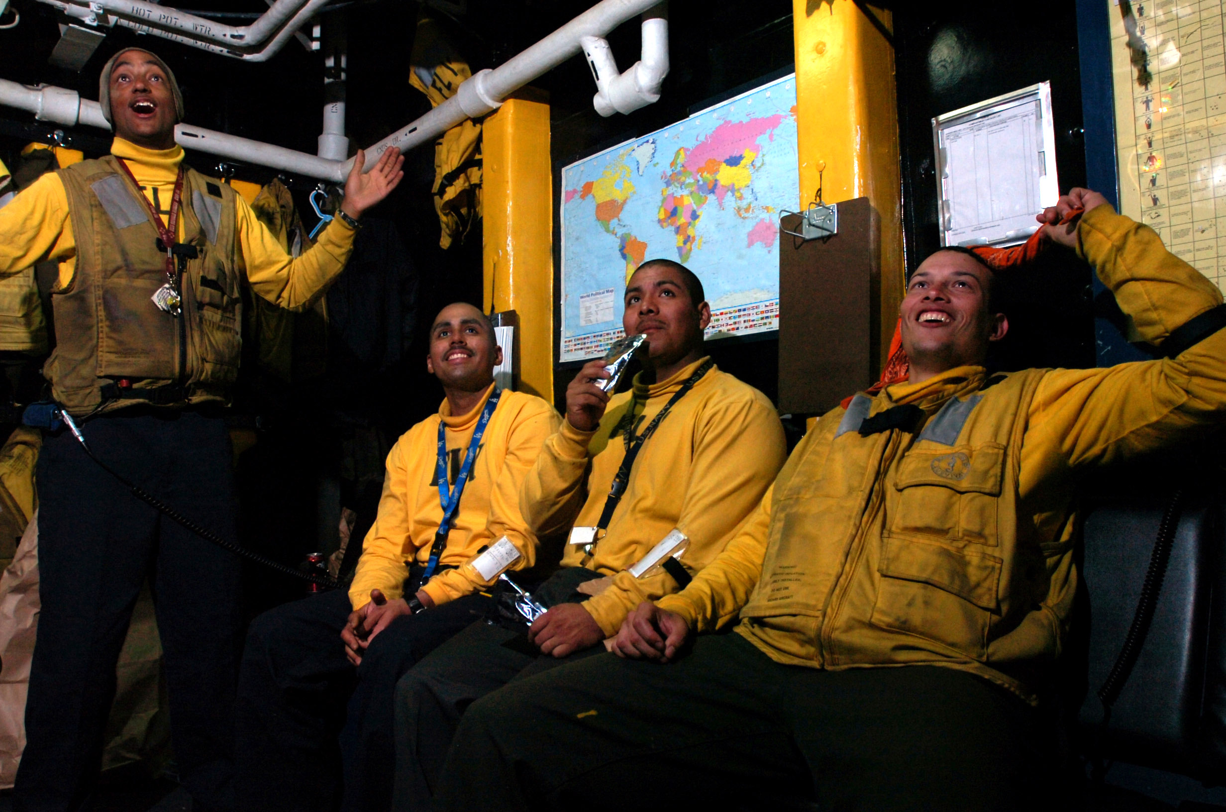 US Navy 070204-N-0555B-158 Just off the flight deck aboard Nimitz-class aircraft carrier USS Ronald Reagan (CVN 76), aviation boatswain's mates (Handling) use their time in between launch cycles to watch Super Bowl XLI