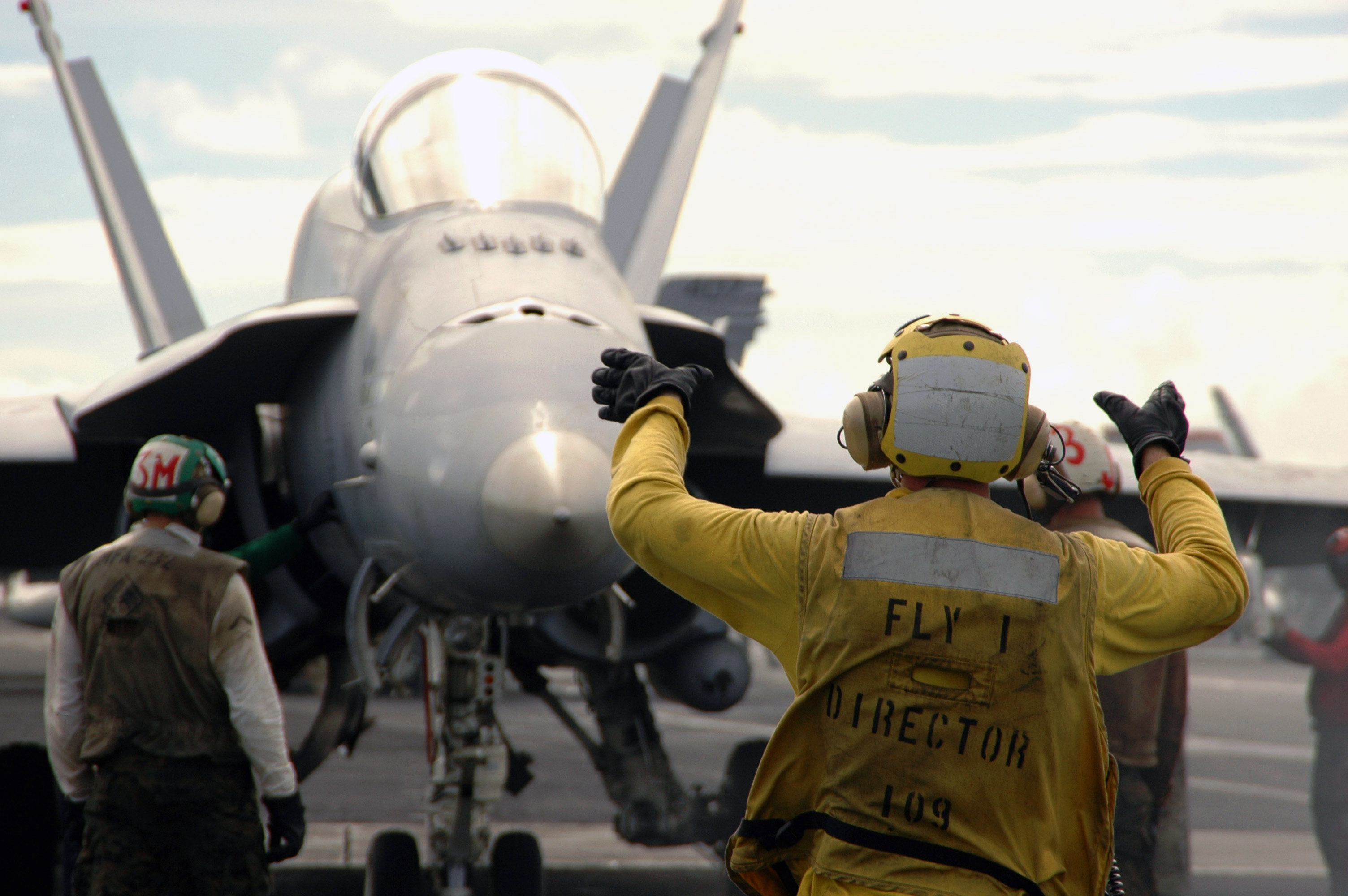 US Navy 070807-N-8119R-050 Aviation Boatswain^rsquo,s Mate (Handling) Airman Anthony Raymond directs an F-A-18A Hornet, assigned to the 