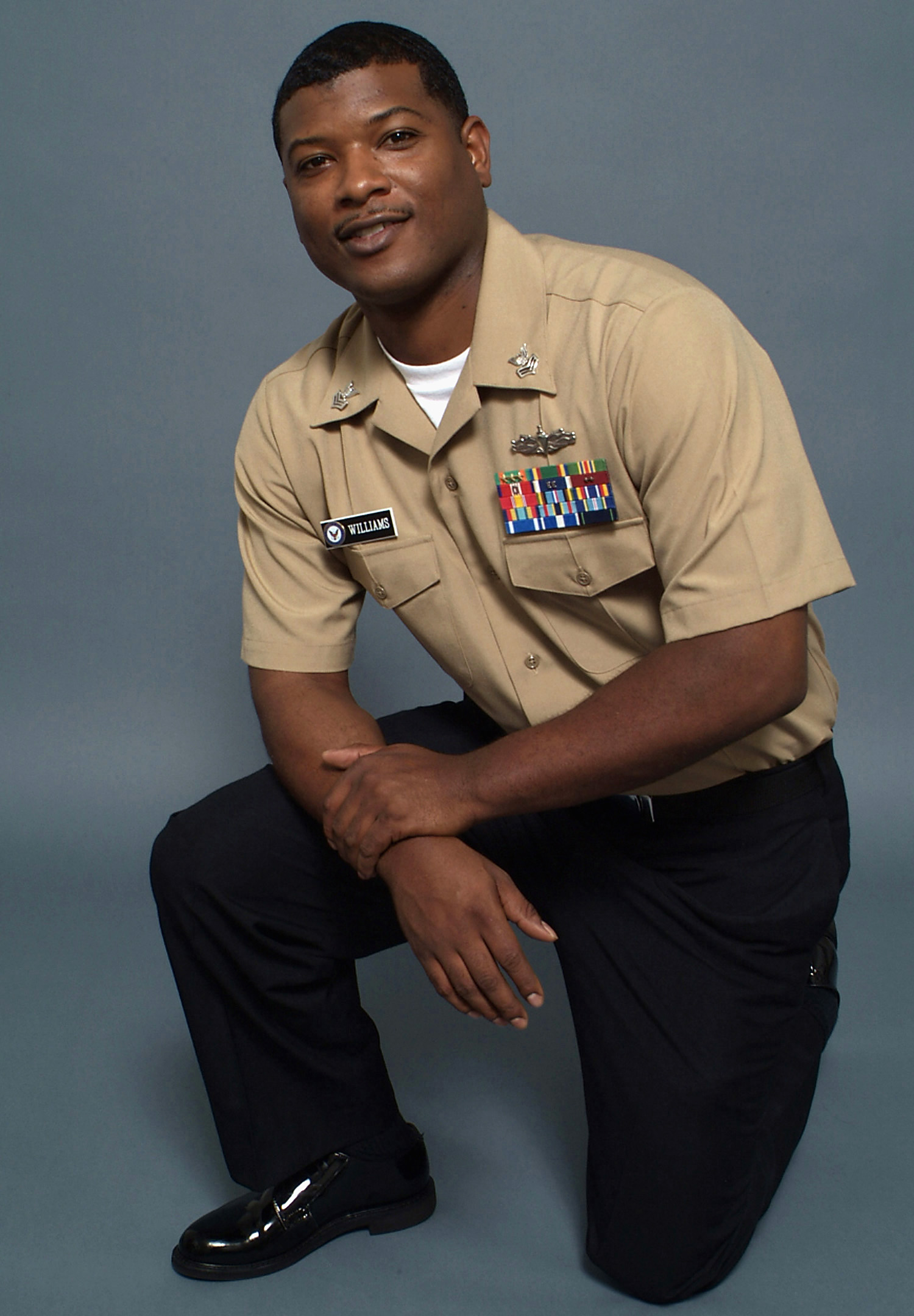US Navy 080730-N-7090S-004 Personnel Specialist 1st Class Howard Williams models the new E-6 and below Service Uniform (SU). The SU is for year-round wear and replaces summer white and winter blue uniforms