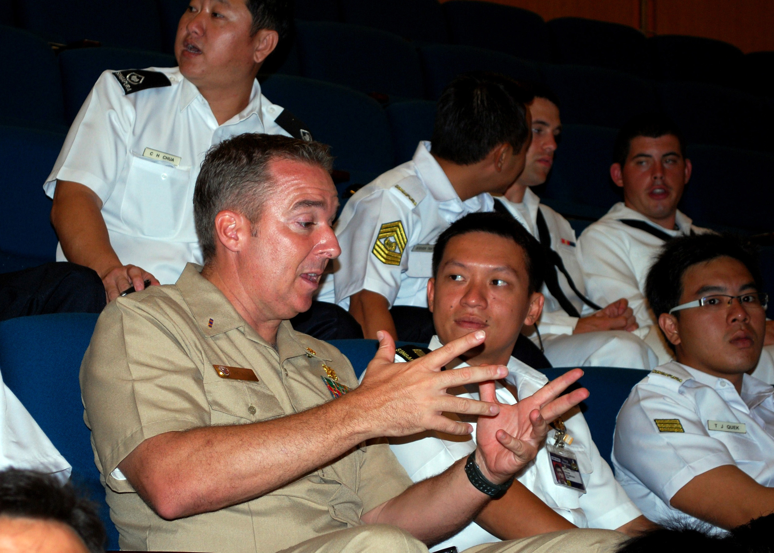 US Navy 090619-N-0869H-017 Chief Warrant Officer Troy Roat, assigned to Mobile Diving and Salvage Unit (MDSU) 1, Company 14, speaks with a Republic of Singapore Navy officer