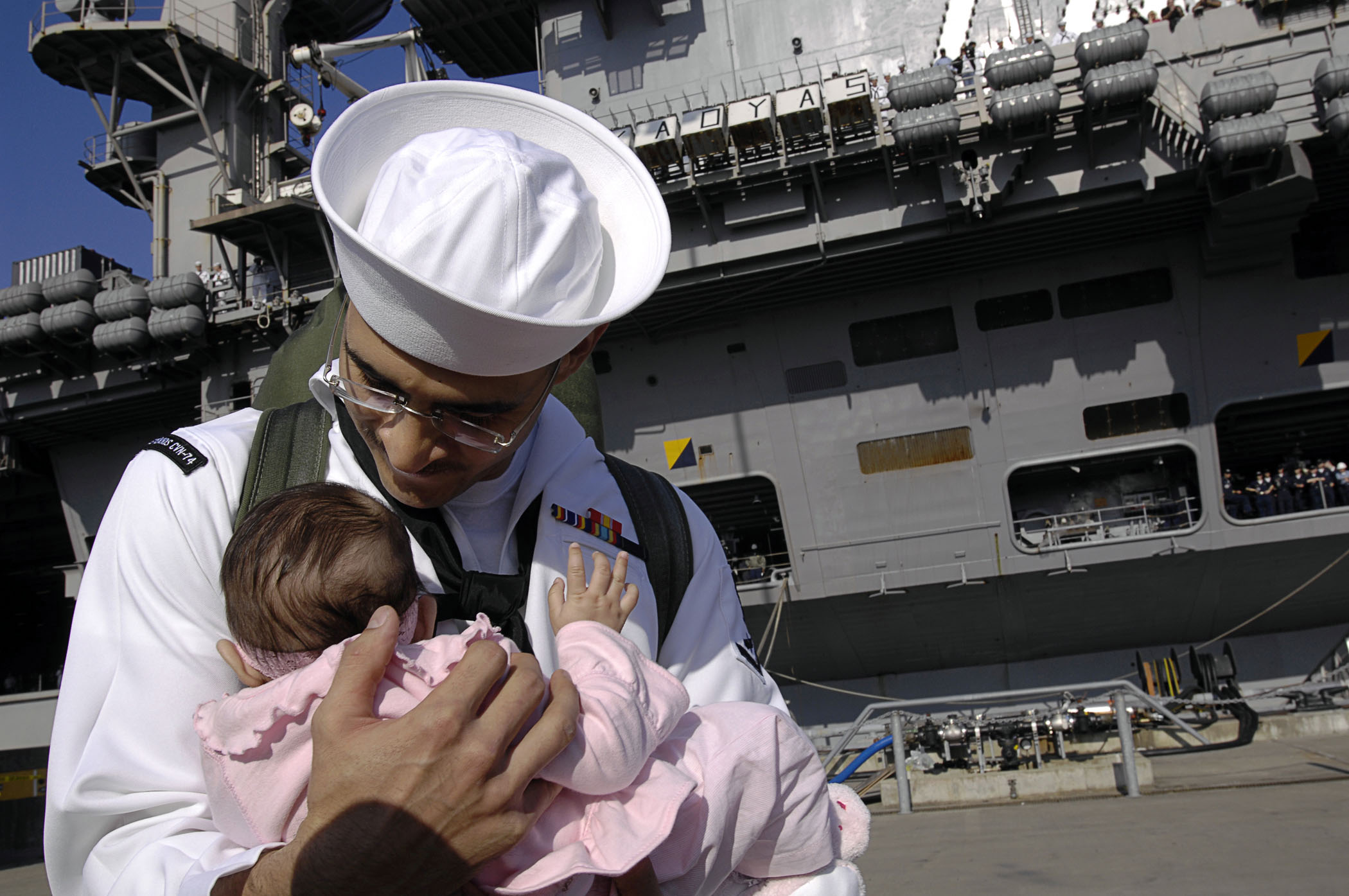 US Navy 090710-N-4954I-041 Aviation Ordnanceman 3rd Class Gilberto Arambul, from Brownsville, Texas, holds his three-and-a-half month-old daughter for the first time
