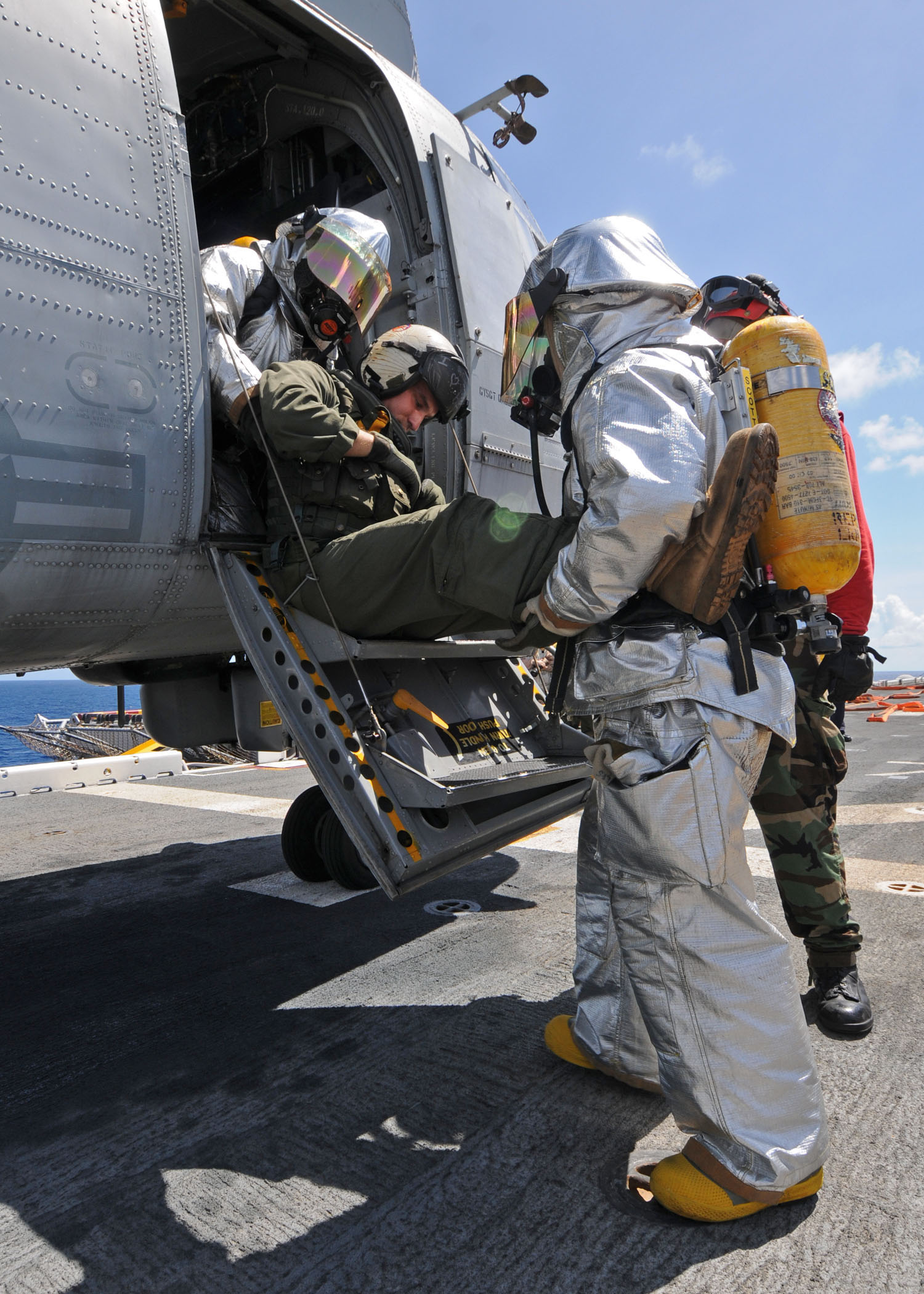 US Navy 101016-N-3237D-090 A crash and salvage team removes an injured Sailor from a helicopter during a mass casualty drill aboard the multi-purpo