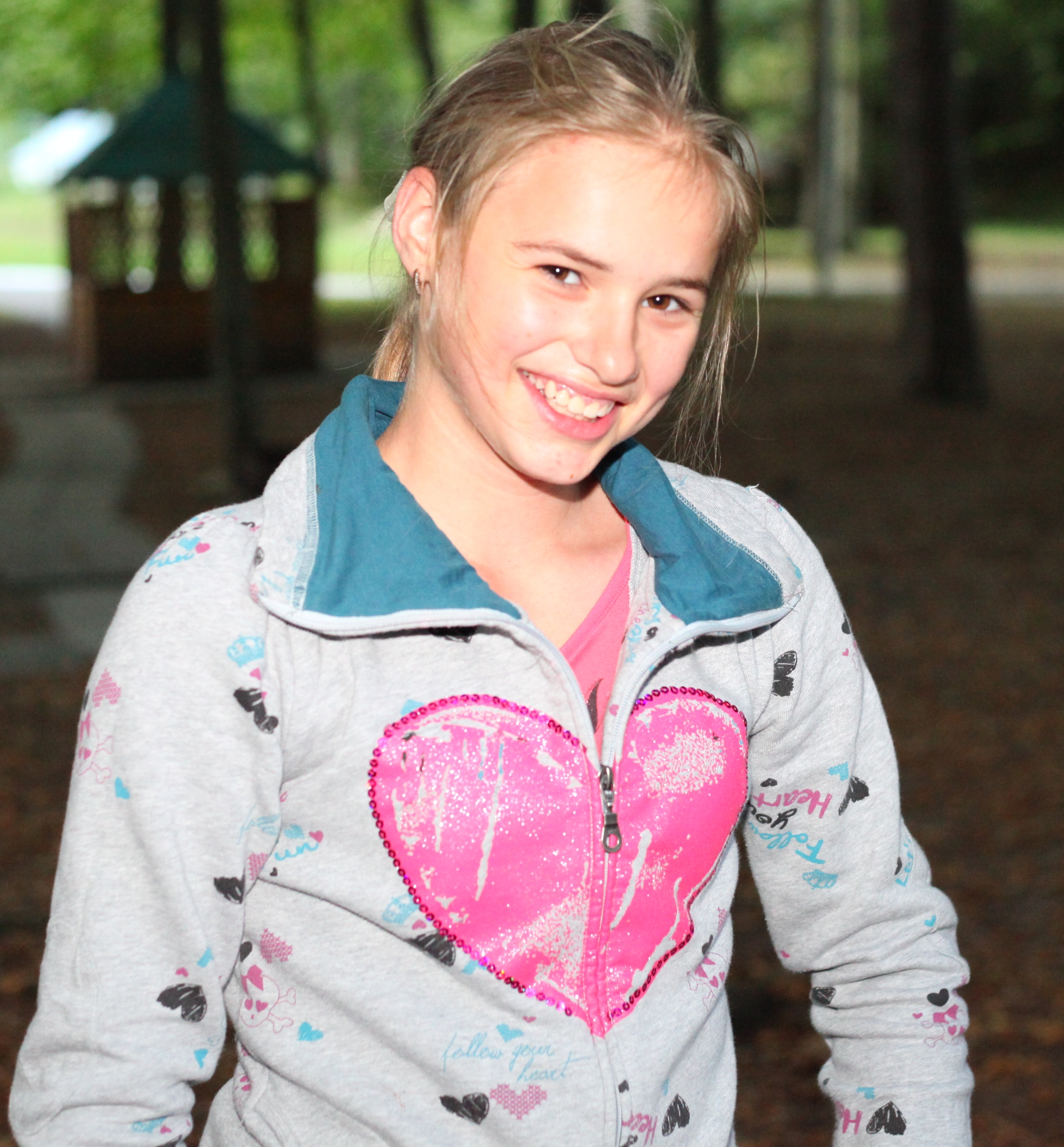 a beautiful appealing smiling Catholic girl in a park, picture 13