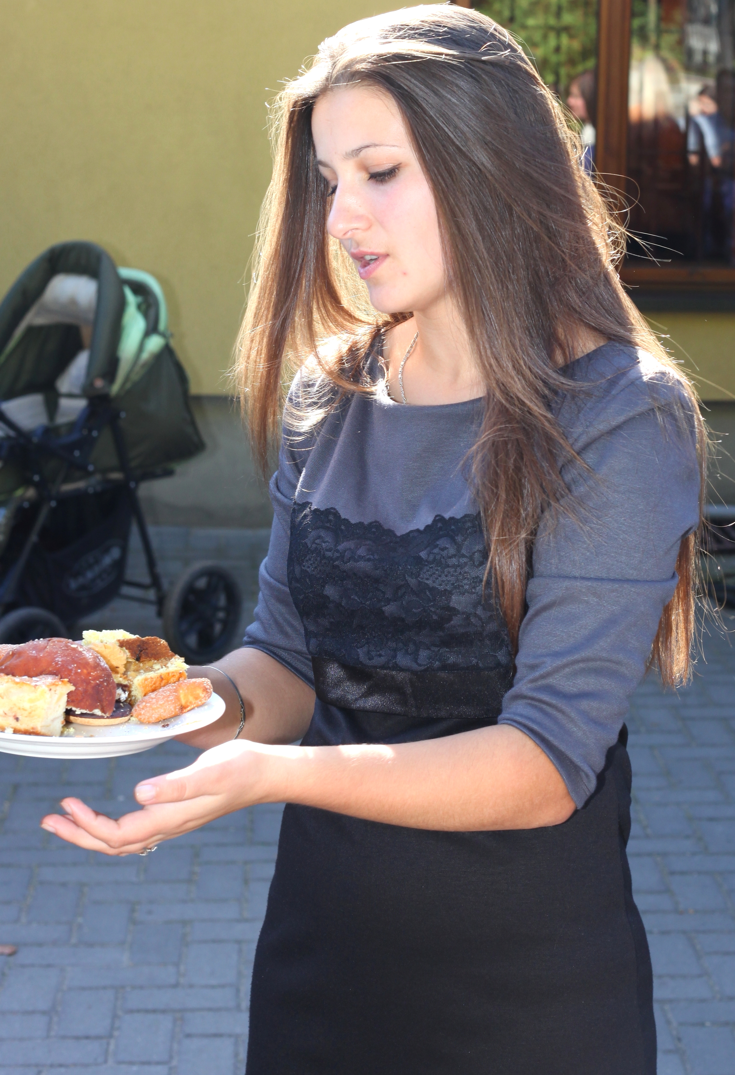 a beautiful brunette Catholic girl with sweets near a Church, photo 32