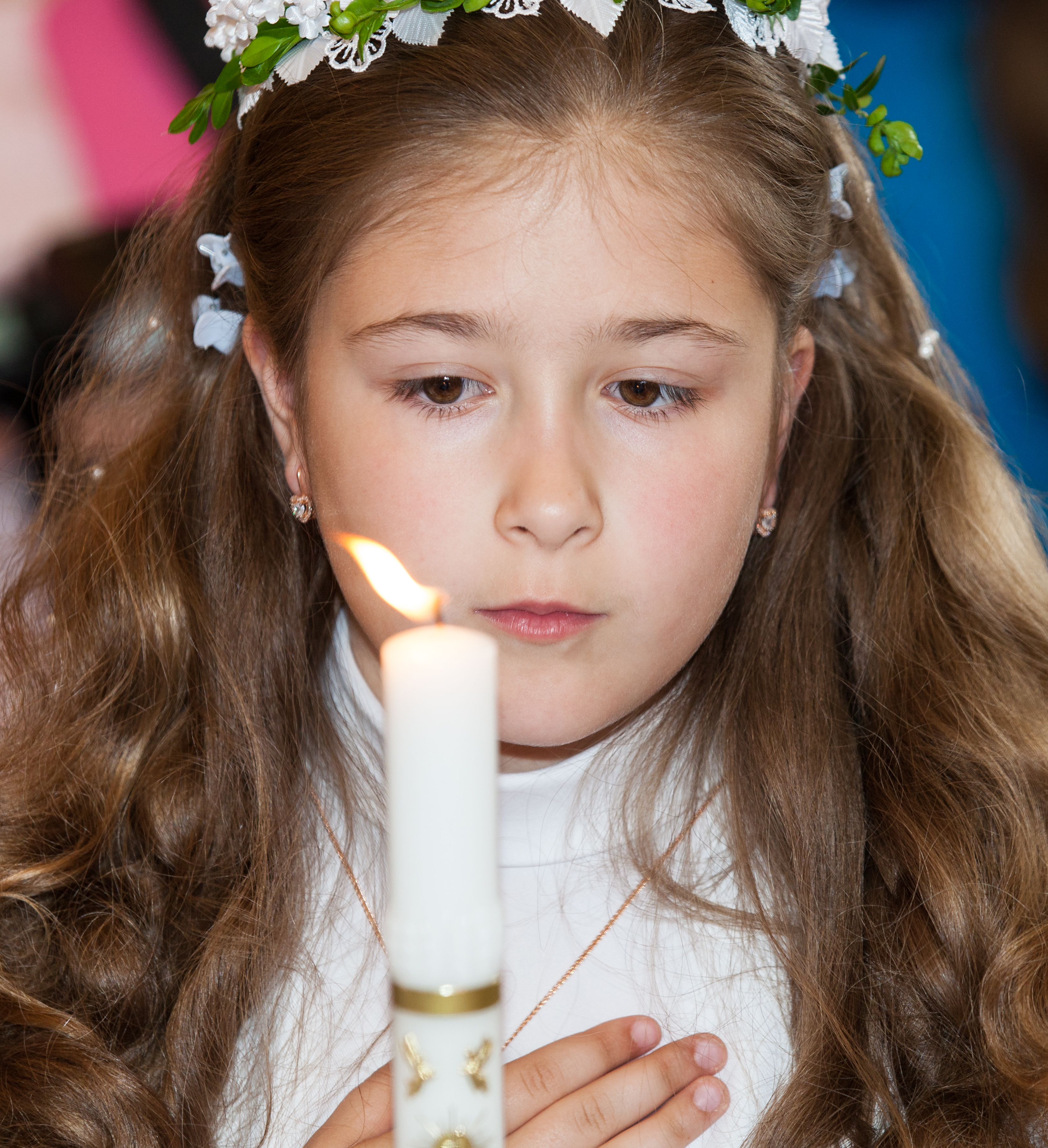 a Catholic child girl with a candle on her first Holy Communion Mass in June 2014, picture 4/4