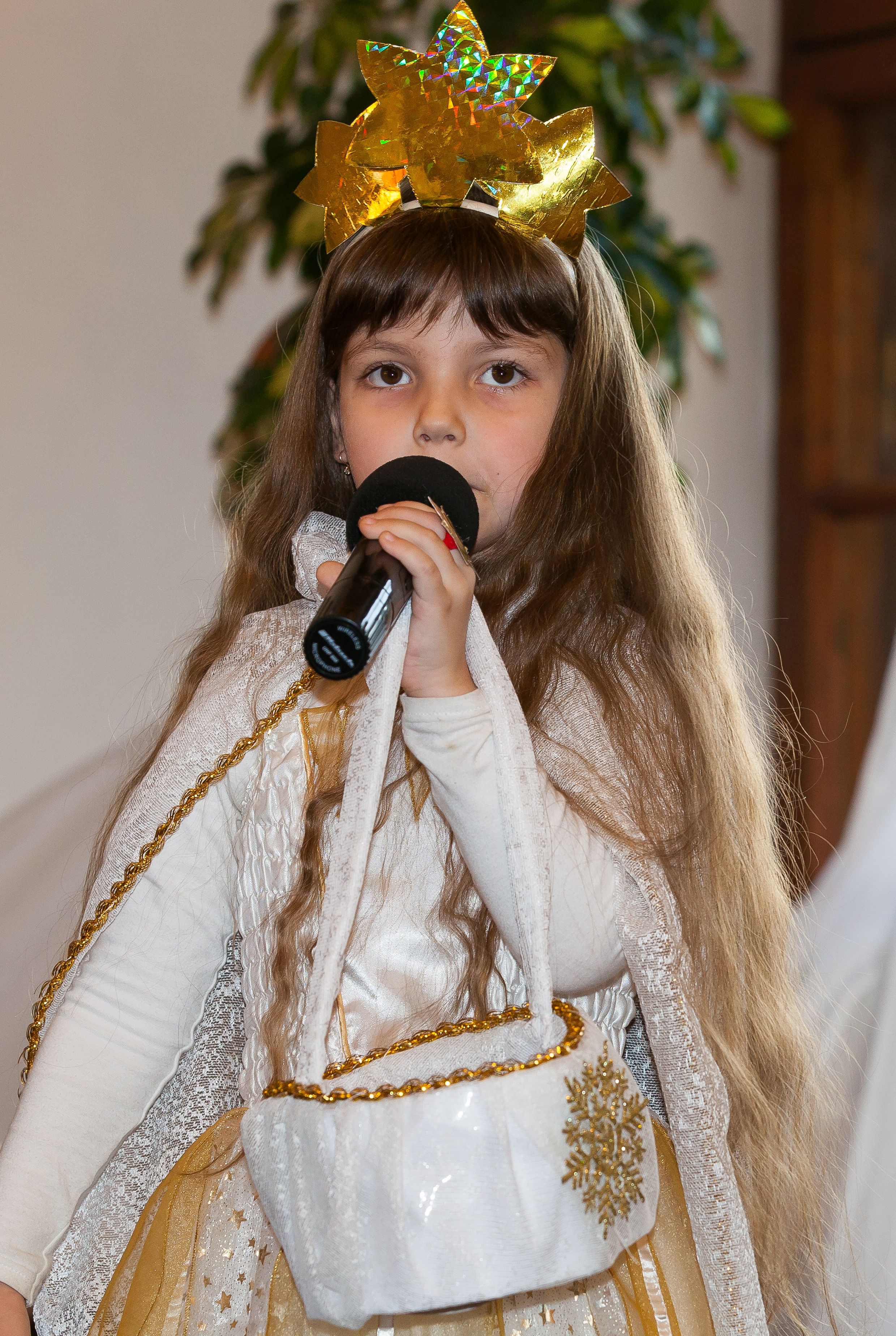 a cute Christian kid girl performing in a Catholic kindergarten in December 2013