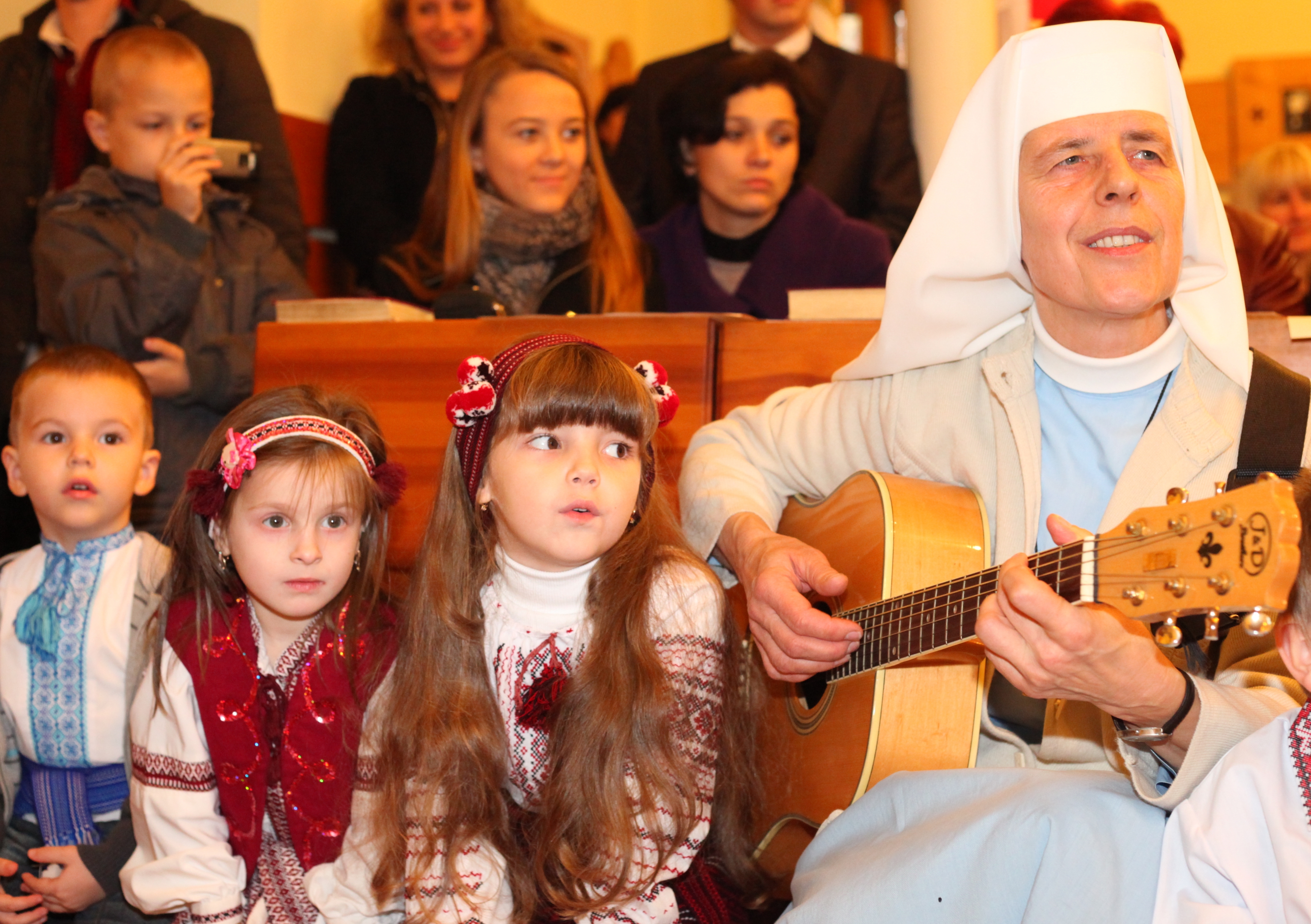 a nun playing guitar in a Catholic Church