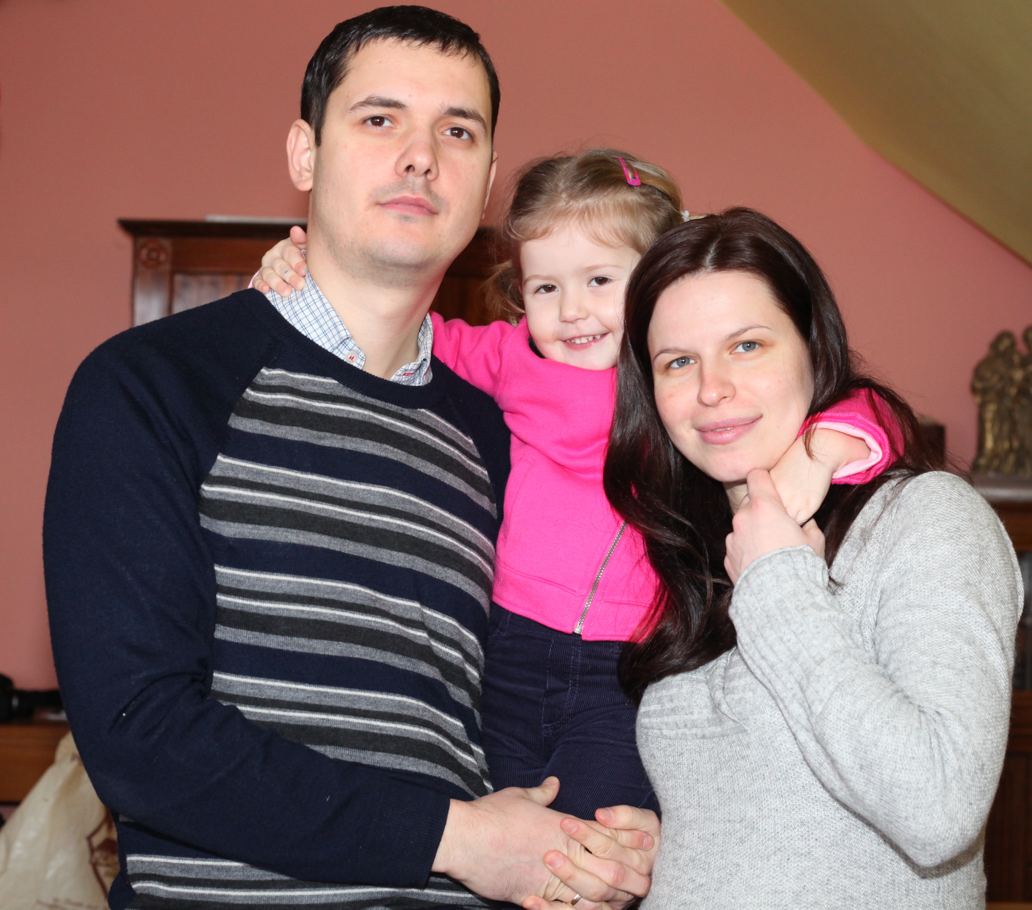a beautiful brunette pregnant Catholic woman with her husband and daughter, picture 9
