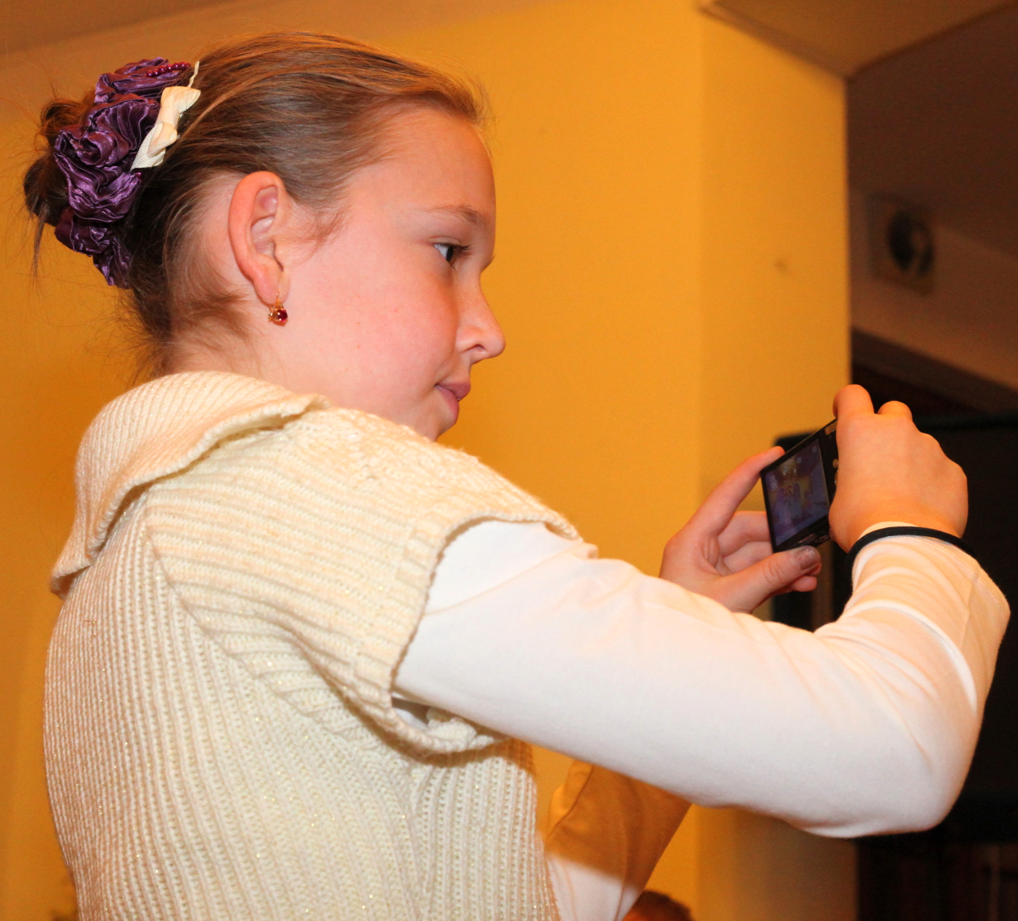 a pretty fair-haired girl taking a photo in a Church, photo 2
