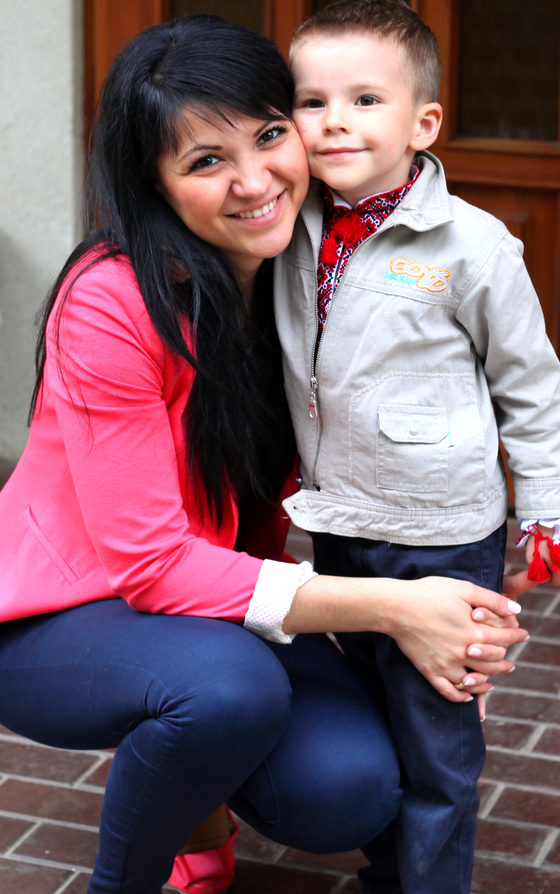 a sweet brunette Catholic woman with her son in a Catholic kindergarten in May 2013