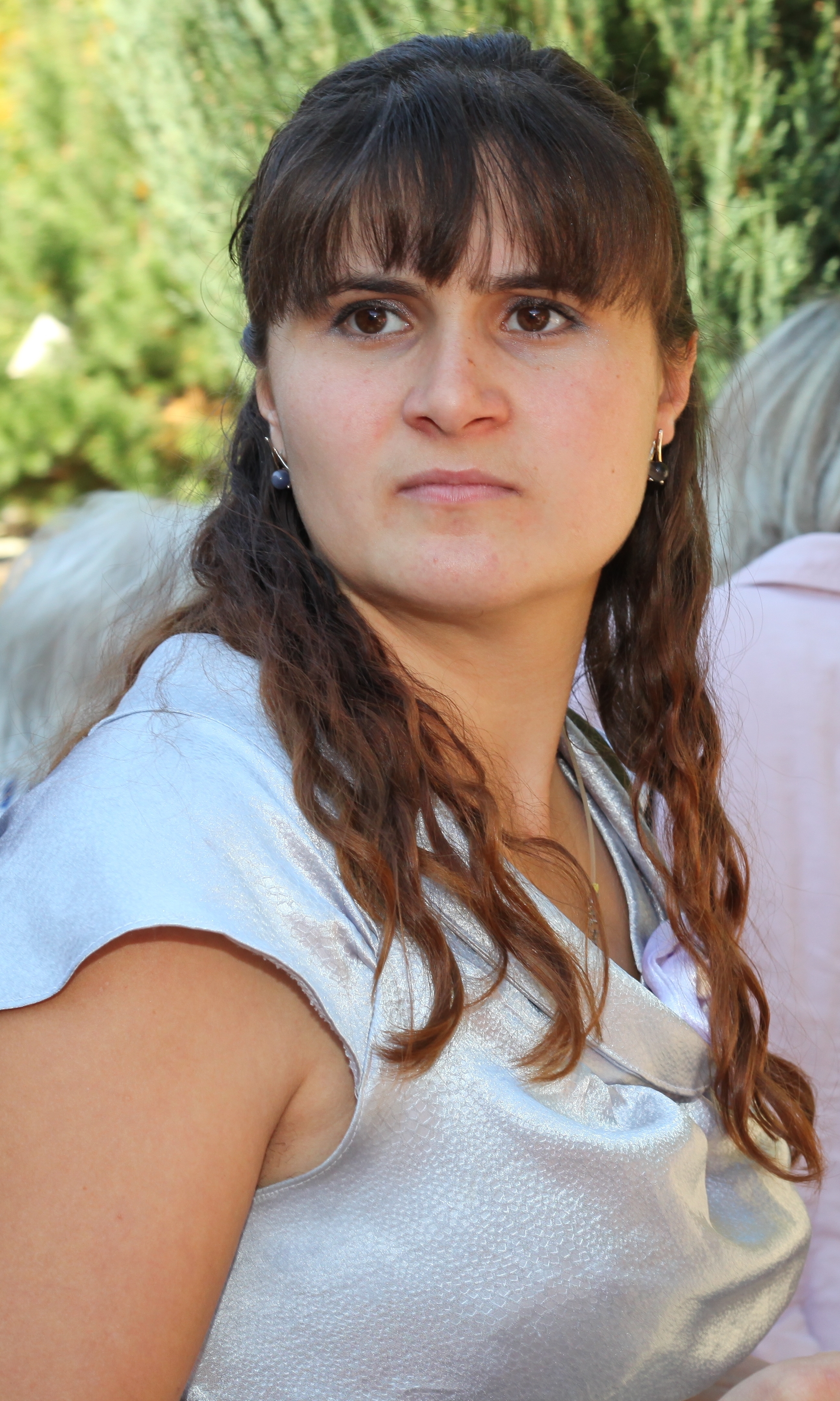 a young pretty brunette Catholic woman near a Church