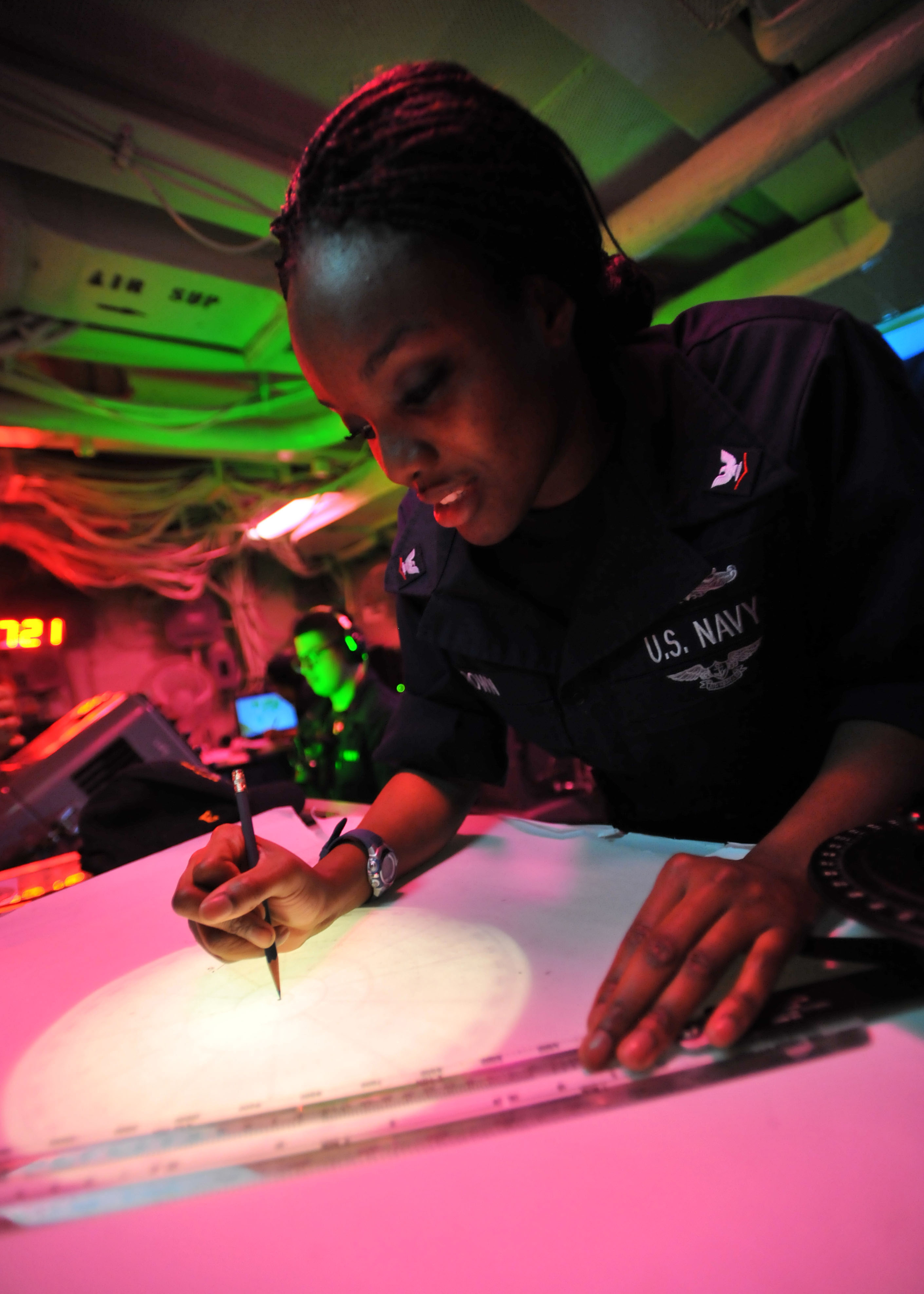 Defense.gov News Photo 110308-N-0569K-048 - Petty Officer 3rd Class Lakysha Brown uses the dead reckoning tracer to plot the ship s course and speed in the commanding officer s tactical plot