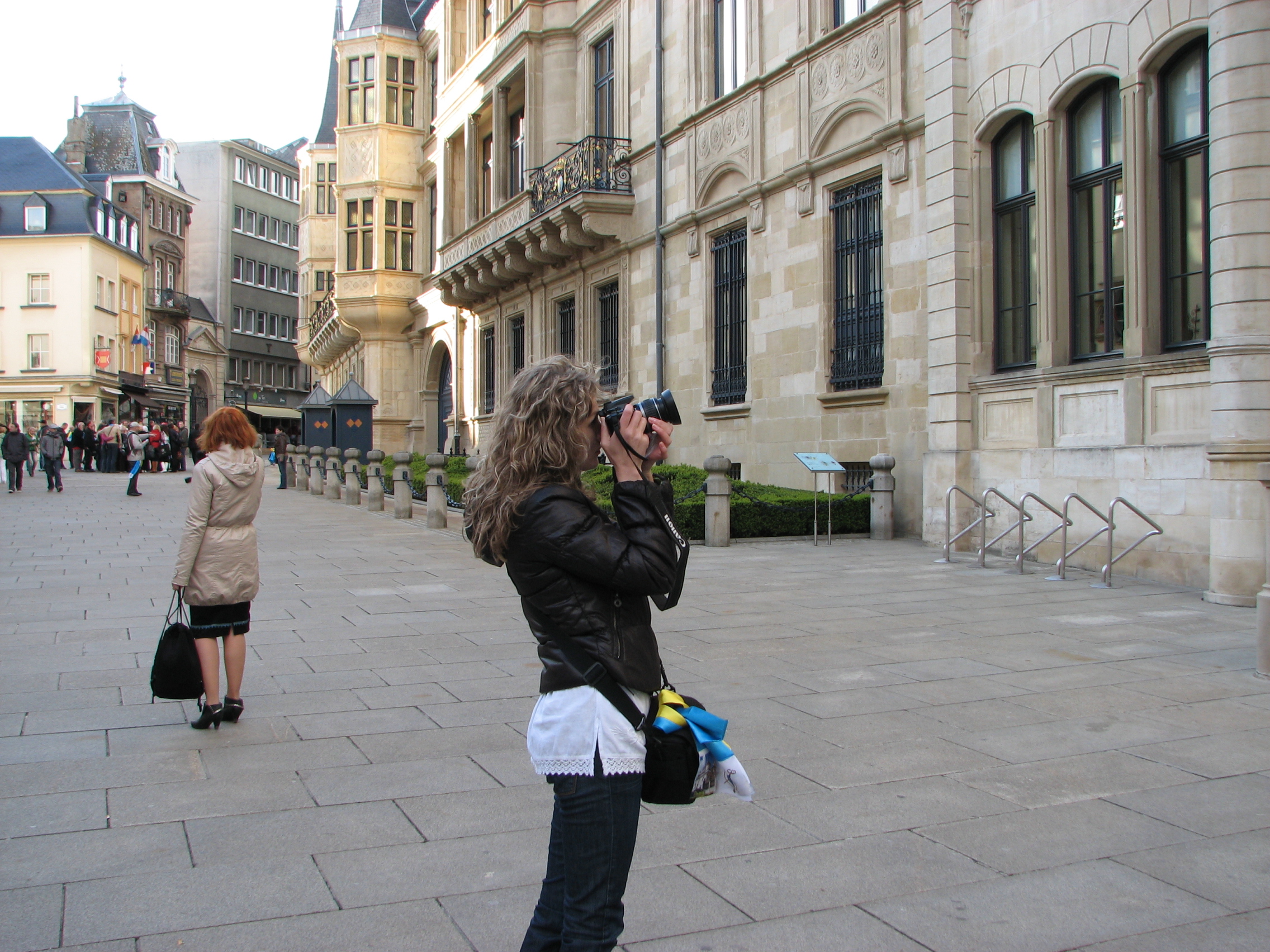 A girl taking a photo with a Canon DSLR