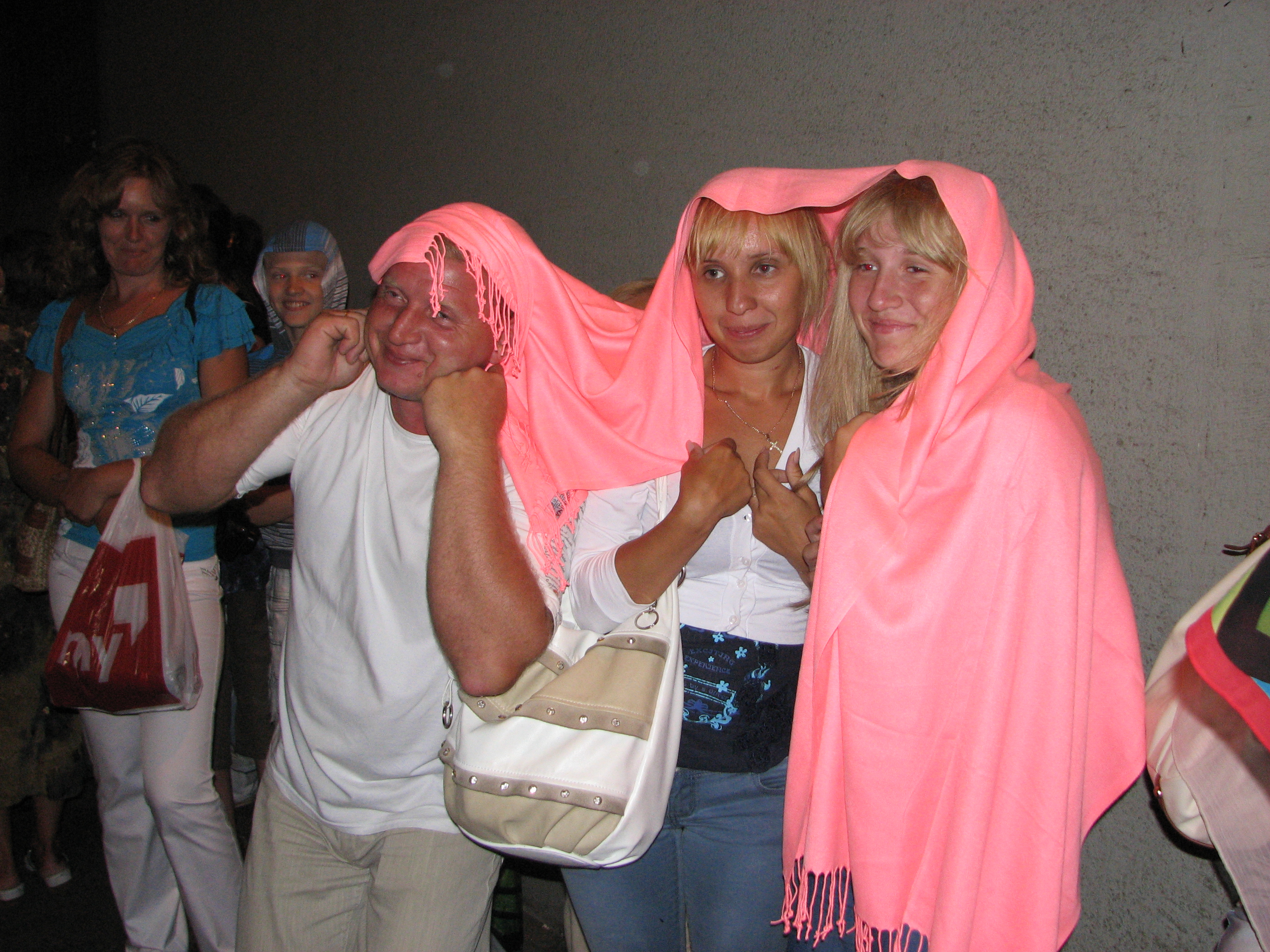 A man, young woman and a girl hiding from rain in Prague (Praha) city, Czech Republic, European Union, picture 37