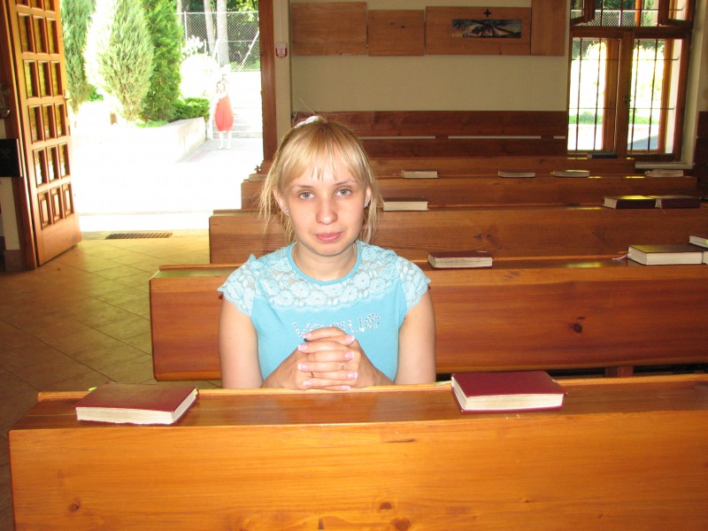 A praying woman in Catholic chapel in Lviv, Ukraine. June 2012.