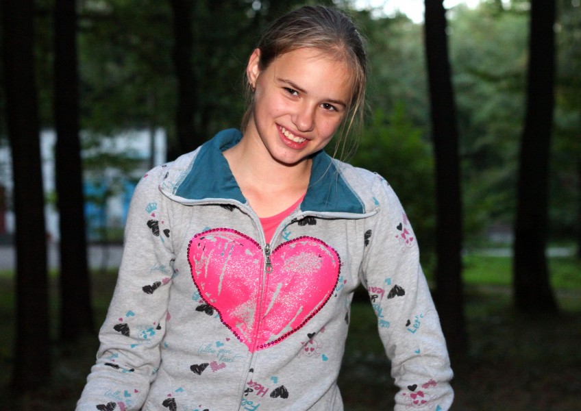 a beautiful appealing smiling Catholic girl in a park, picture 19