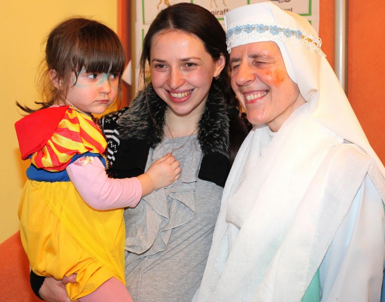 a beautiful brunette Catholic woman with her cute daughter and a nun in a Catholic kindergarten, photo 2