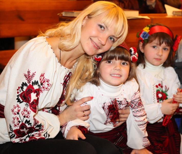 an amazingly tender and charming beautiful young blond Catholic woman with her daughter in a Church, photo 21