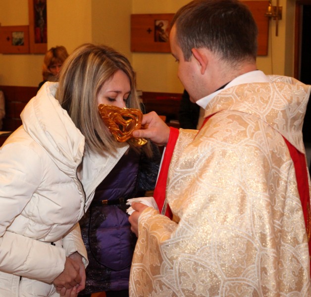 a beautiful young Catholic woman in a Church kissing relics of a saint, photo 2