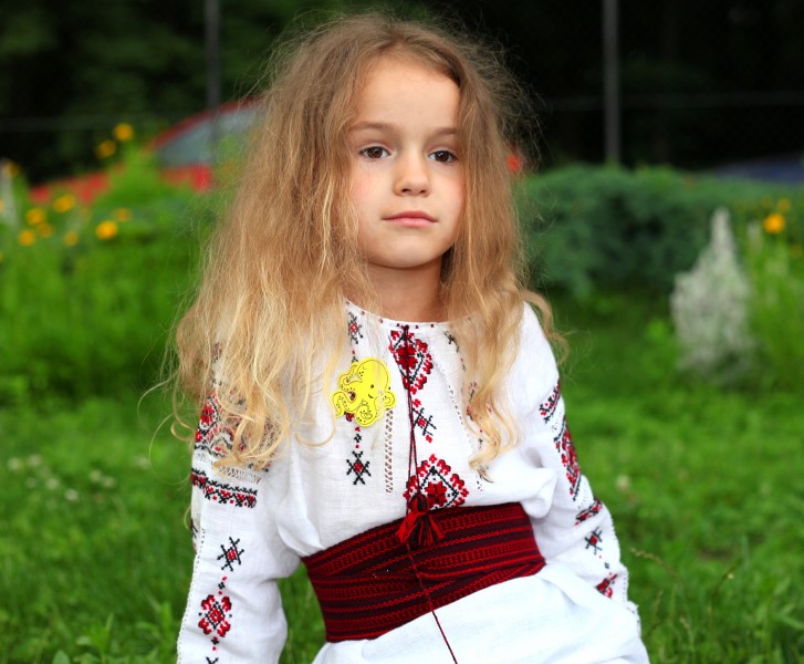 a cute blond Catholic child girl in a Catholic kindergarten in June 2013, picture 1/2