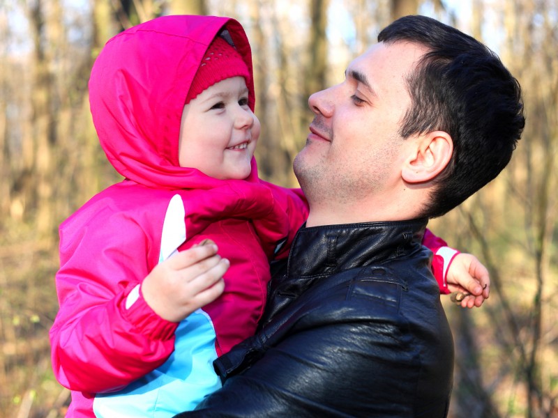 a handsome Catholic father with his cute daughter in a forest, picture 2