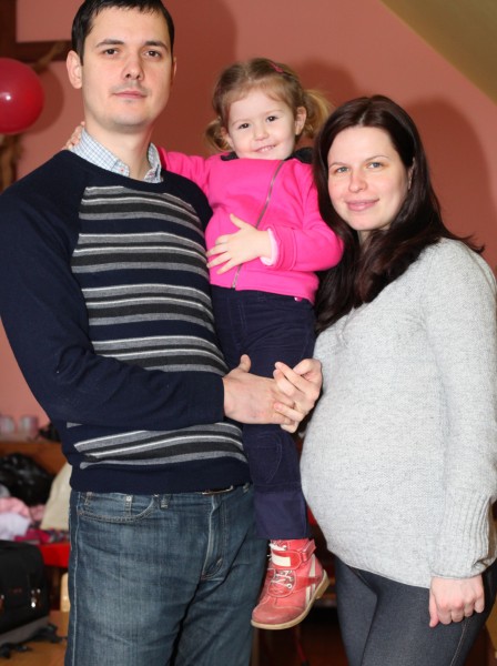 a pregnant beautiful brunette Catholic woman with her husband and daughter, picture 11
