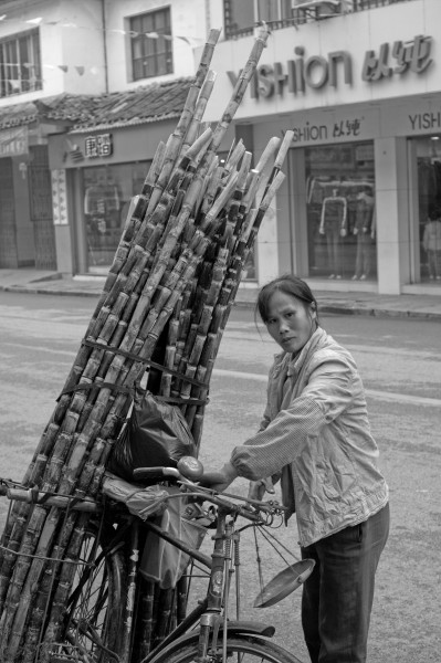 A woman is selling some cane
