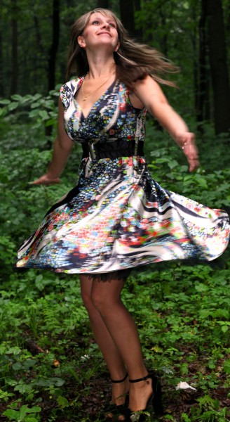 a young Catholic woman wearing a colorful dress in a forest in June 2013, portrait 3/9