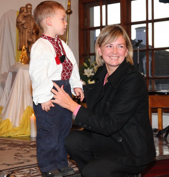 a young pretty woman with her son in a Catholic Church