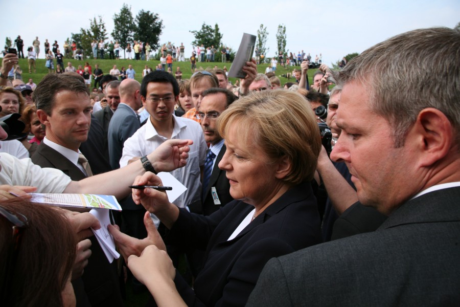 B Angela Merkel signing autographs 1