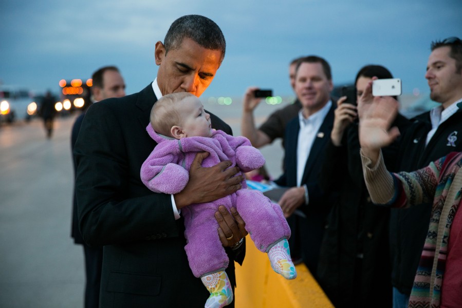 Barack Obama kisses a baby at Denver International Airport, 2012