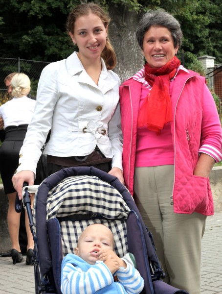 Catholic women and a baby near a Church