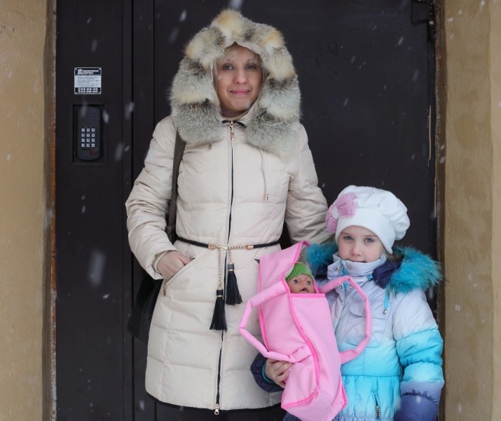 a mother with her daughter going out in winter